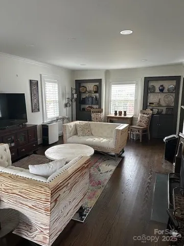 a spacious bedroom with a bed a couch and wooden floor