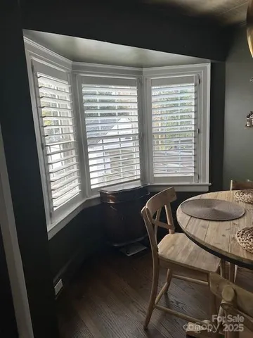 a dining room with furniture and a window