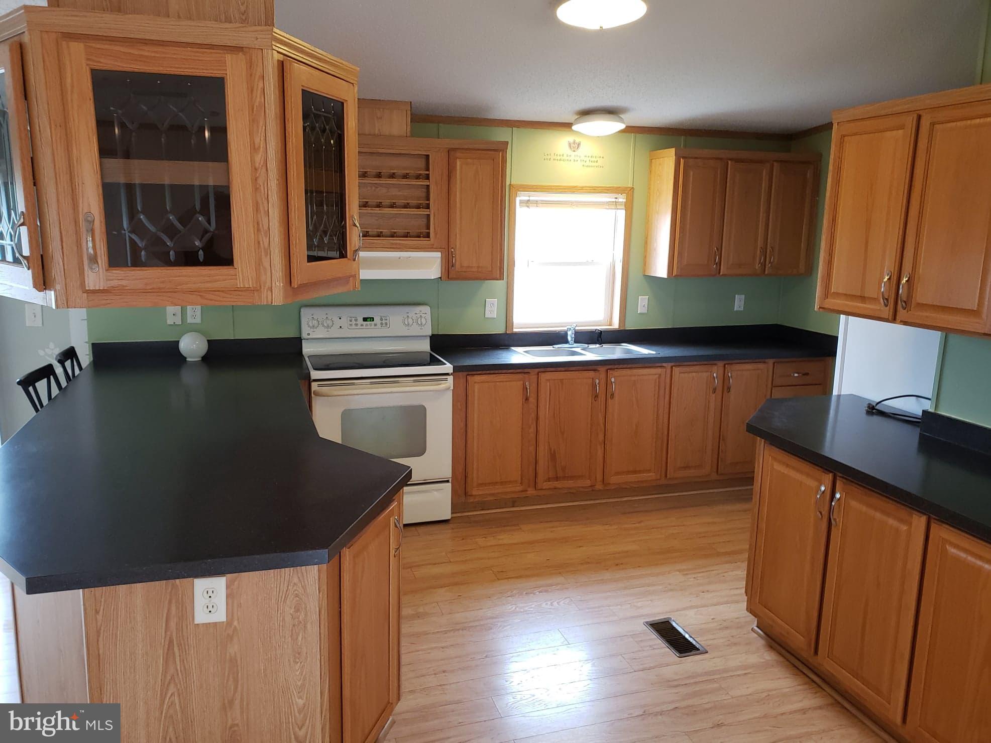 2 New Bridge Road, Unit A3 Quinton, NJ 08079 - Photo 3 of 15 a kitchen with granite countertop a stove a sink and a refrigerator