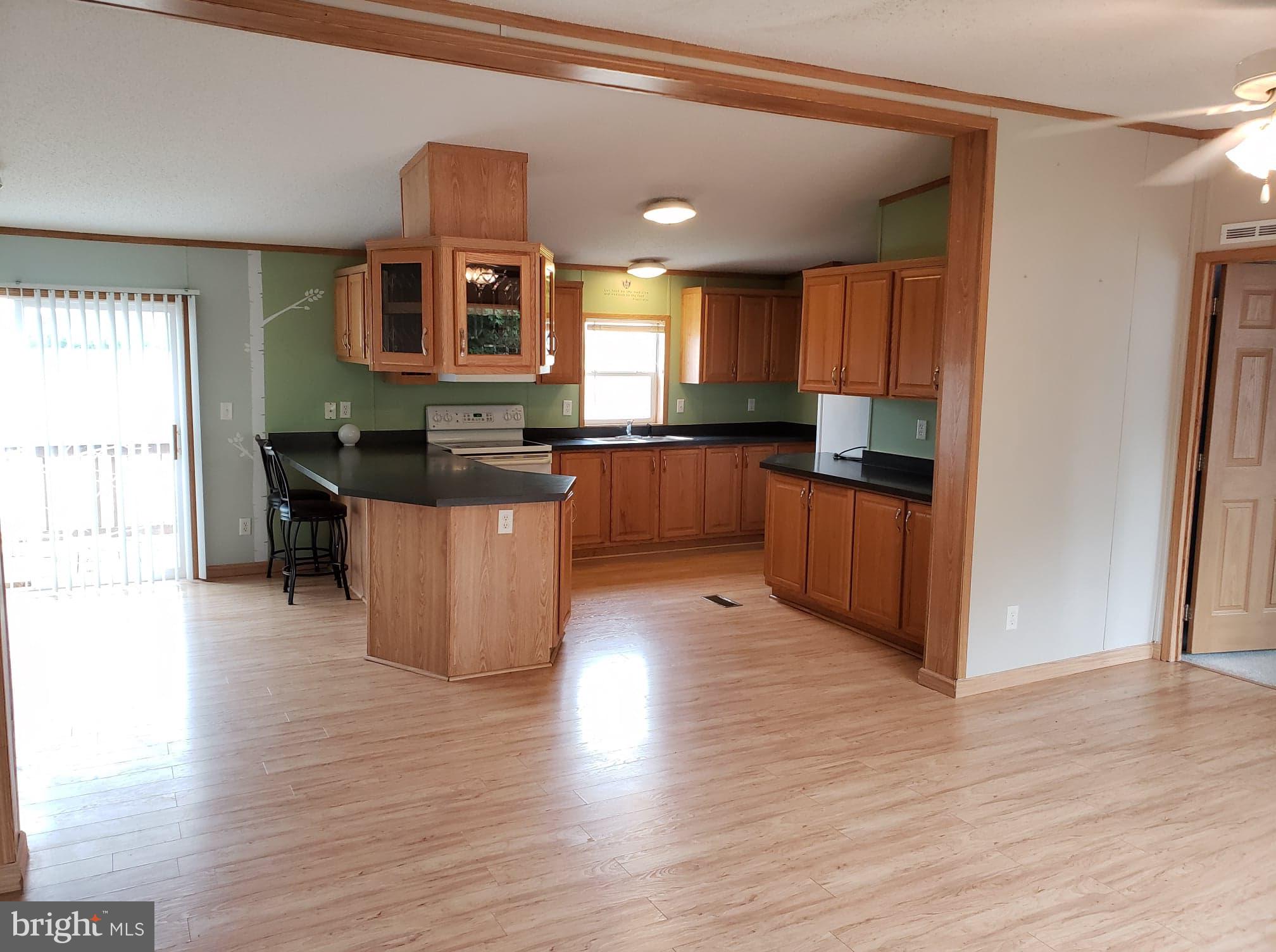 2 New Bridge Road, Unit A3 Quinton, NJ 08079 - Photo 4 of 15 a kitchen with granite countertop a stove top oven and cabinets