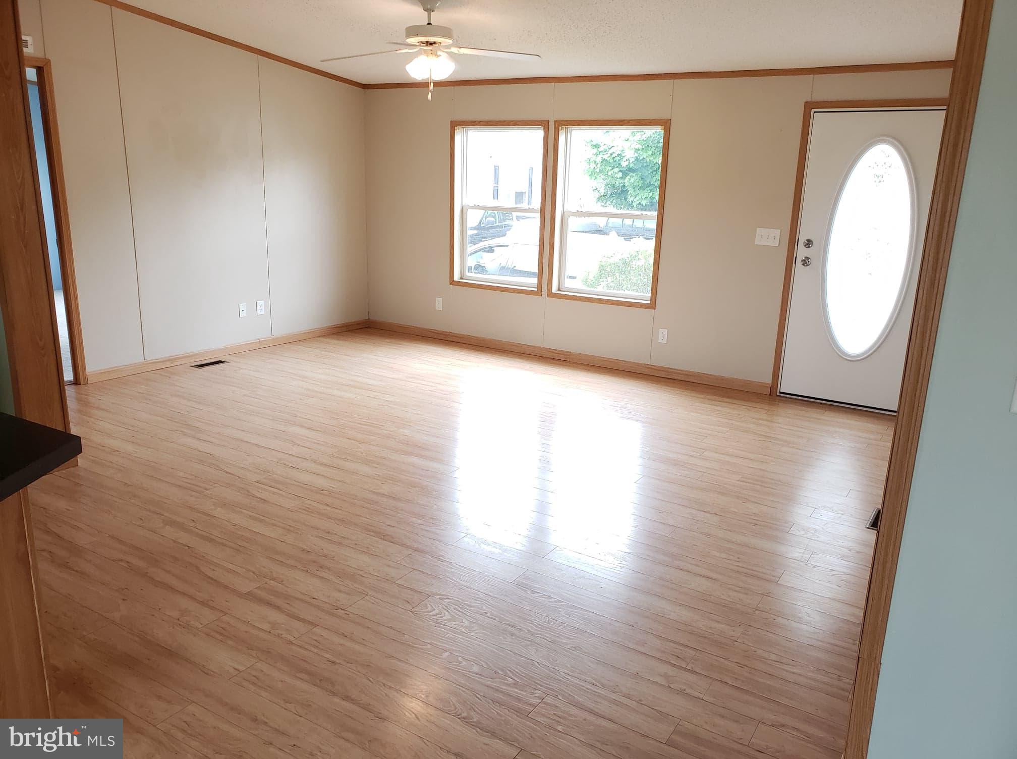 2 New Bridge Road, Unit A3 Quinton, NJ 08079 - Photo 7 of 15 an empty room with wooden floor and windows