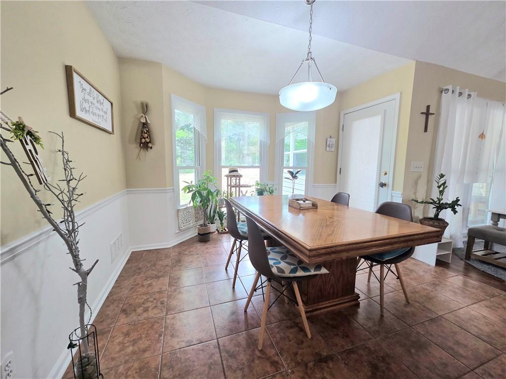 2395 Ashton Ridge Drive Dacula, GA 30019 - Photo 13 of 38 a view of a dining room with furniture and wooden floor