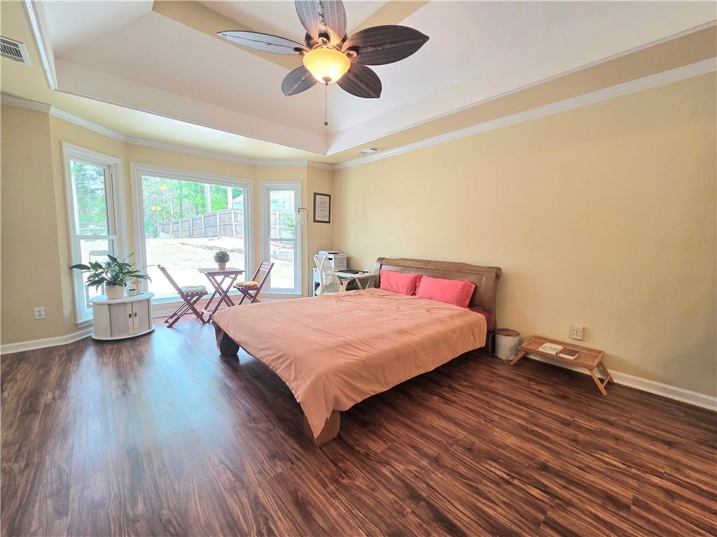 2395 Ashton Ridge Drive Dacula, GA 30019 - Photo 15 of 38 a bedroom with a bed chandelier and a large window