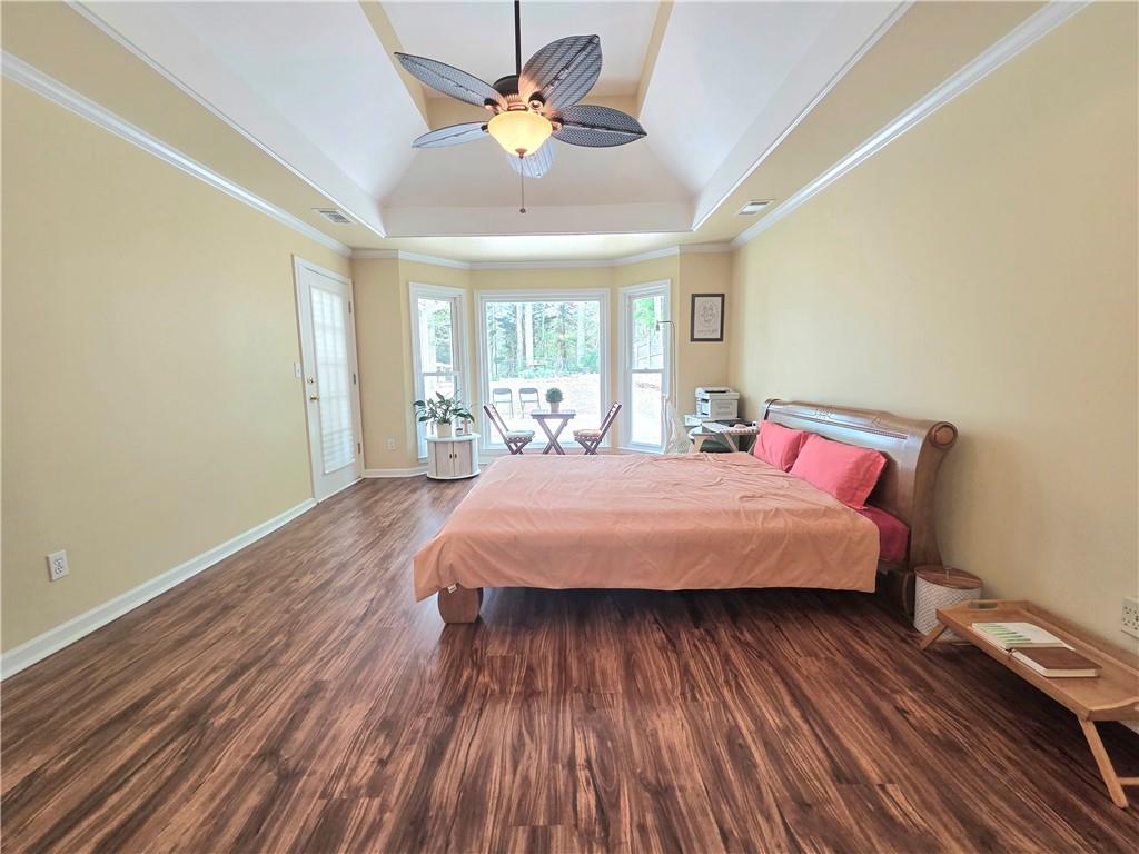 2395 Ashton Ridge Drive Dacula, GA 30019 - Photo 16 of 38 a bedroom with a bed and wooden floor