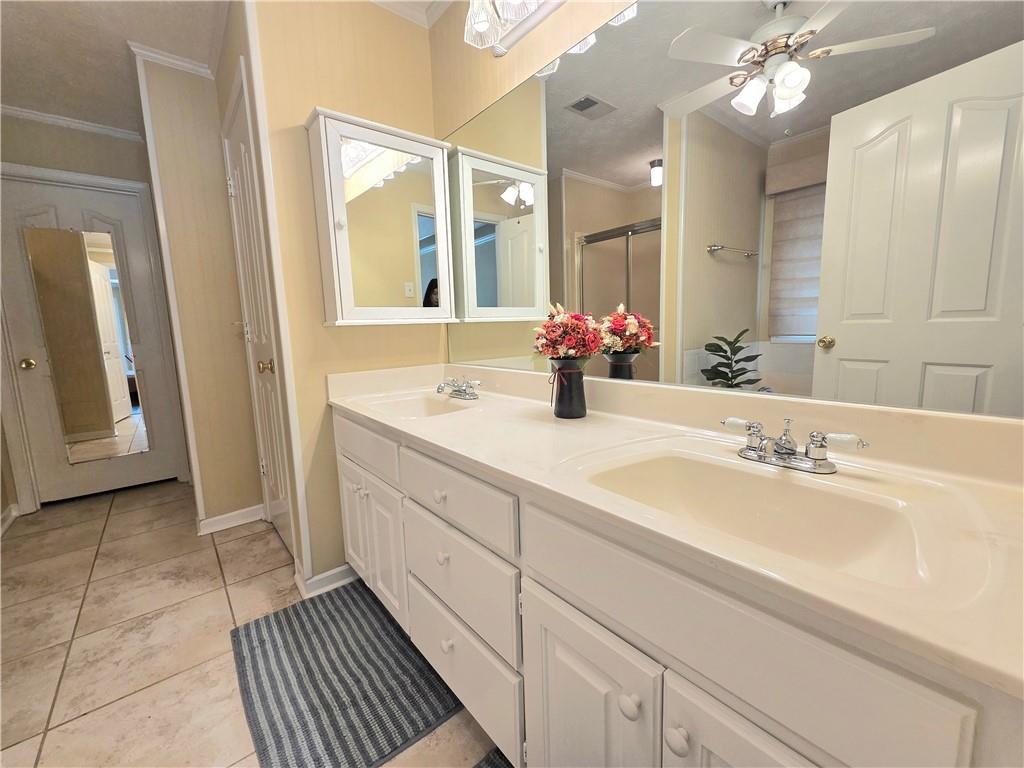 2395 Ashton Ridge Drive Dacula, GA 30019 - Photo 18 of 38 a spacious bathroom with a double vanity sink a mirror and a shower