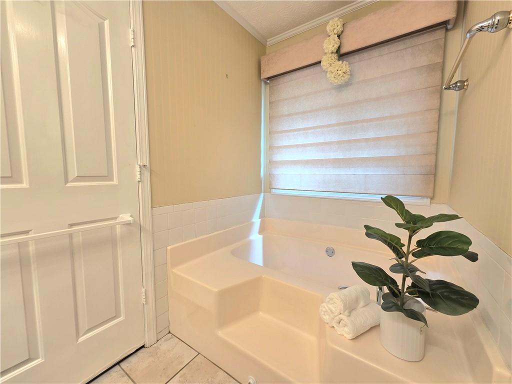 2395 Ashton Ridge Drive Dacula, GA 30019 - Photo 20 of 38 a bathroom with a bathtub