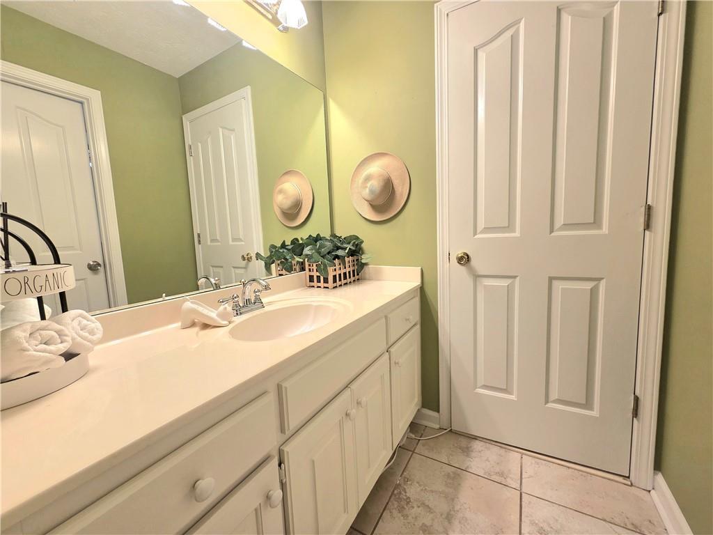 2395 Ashton Ridge Drive Dacula, GA 30019 - Photo 25 of 38 a bathroom with a double vanity sink and a mirror