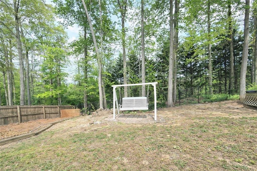 2395 Ashton Ridge Drive Dacula, GA 30019 - Photo 35 of 38 a backyard of a house with trampoline