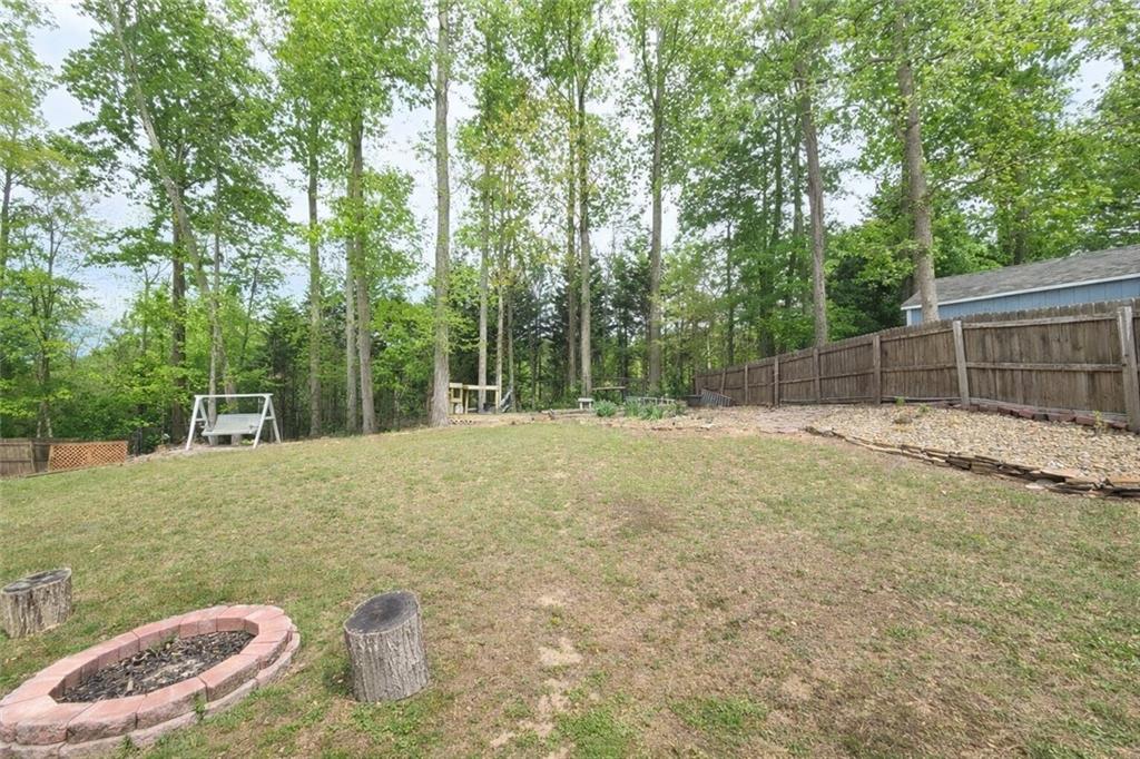 2395 Ashton Ridge Drive Dacula, GA 30019 - Photo 36 of 38 a backyard of a house with table and chairs