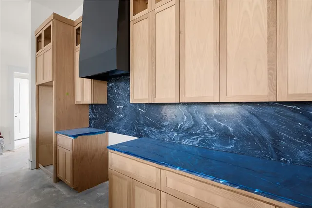 a kitchen with granite countertop white cabinets and stainless steel appliances