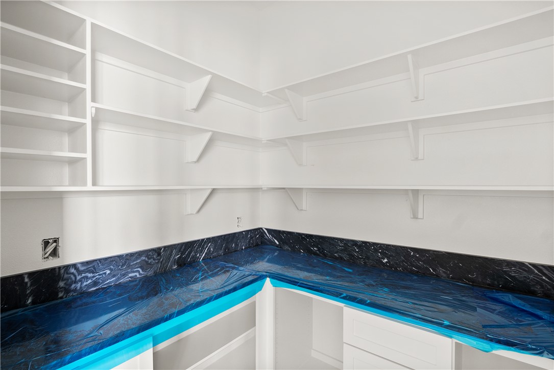 3022 Silverbell Court Bryan, TX 77807 - Photo 12 of 28 a view of a room with wooden floor and shelf