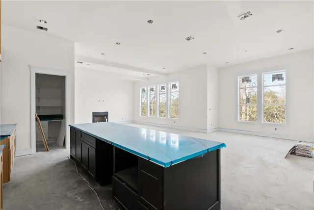 a view of kitchen with stainless steel appliances cabinets