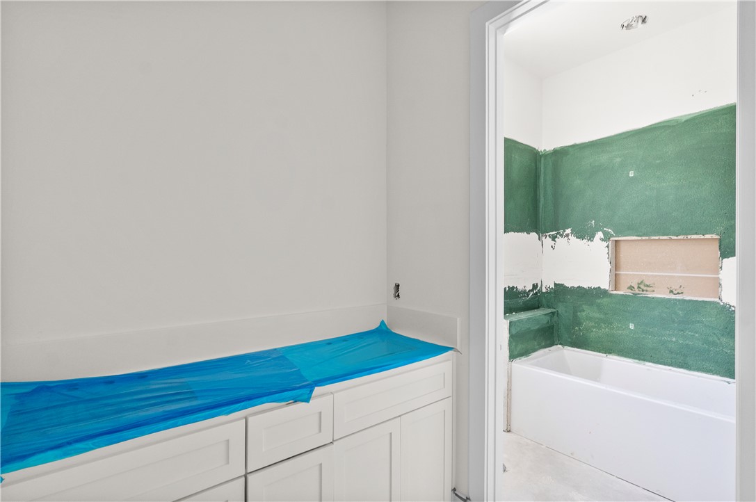 3022 Silverbell Court Bryan, TX 77807 - Photo 19 of 28 a bathroom with a bathtub and shower