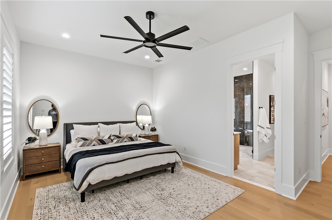 3022 Silverbell Court Bryan, TX 77807 - Photo 25 of 39 a bedroom with a bed and a chandelier