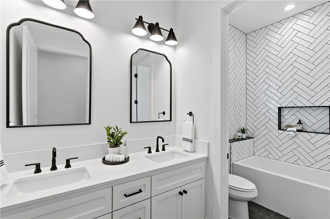 3022 Silverbell Court Bryan, TX 77807 - Photo 31 of 39 a bathroom with a granite countertop sink a toilet and a mirror