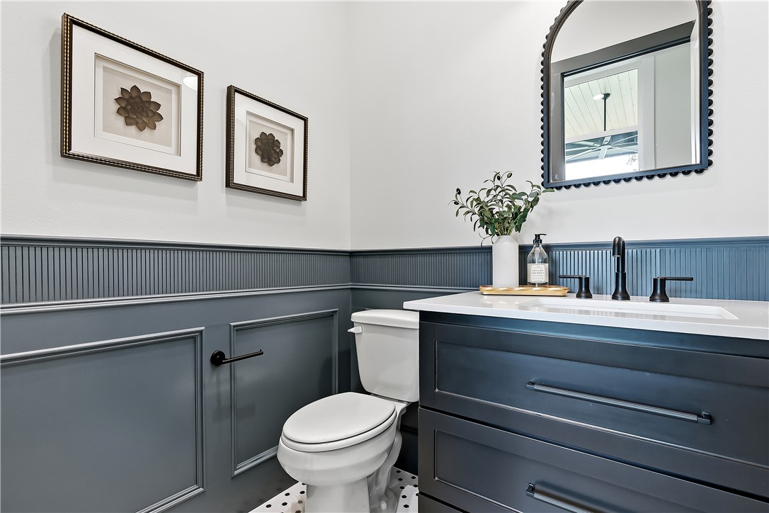 3022 Silverbell Court Bryan, TX 77807 - Photo 34 of 39 a bathroom with a toilet sink and mirror
