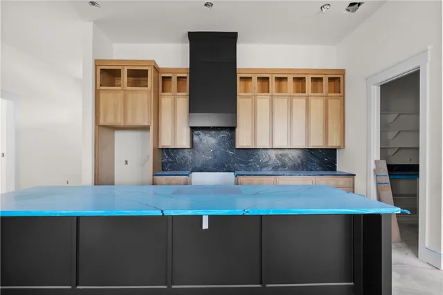 a kitchen with a sink refrigerator and cabinets