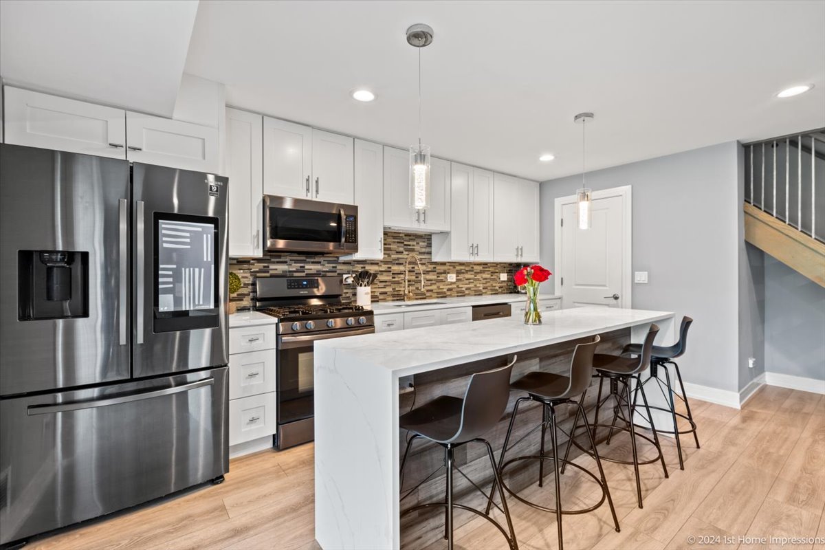 7 Cour Versaille Palos Hills, IL 60465 - Photo 11 of 20 a kitchen with stainless steel appliances a refrigerator stove microwave and cabinets