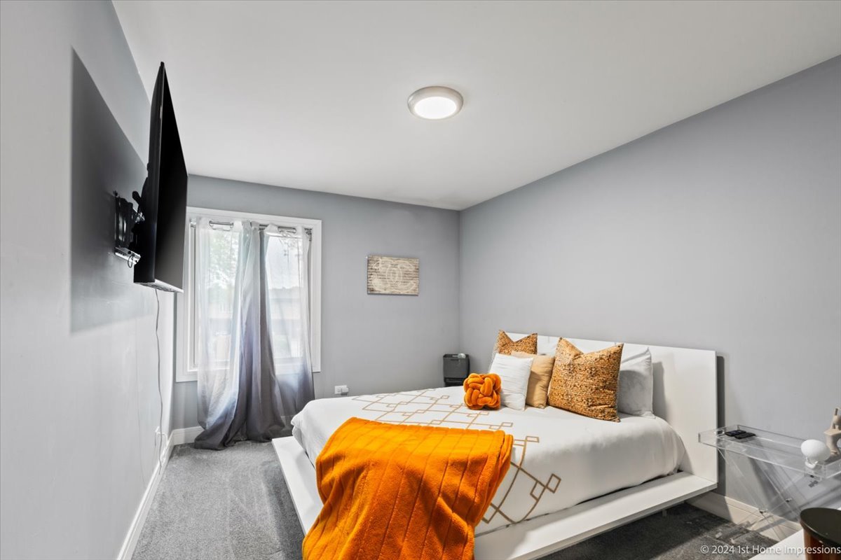 7 Cour Versaille Palos Hills, IL 60465 - Photo 14 of 20 a bedroom with a bed and a flat screen tv