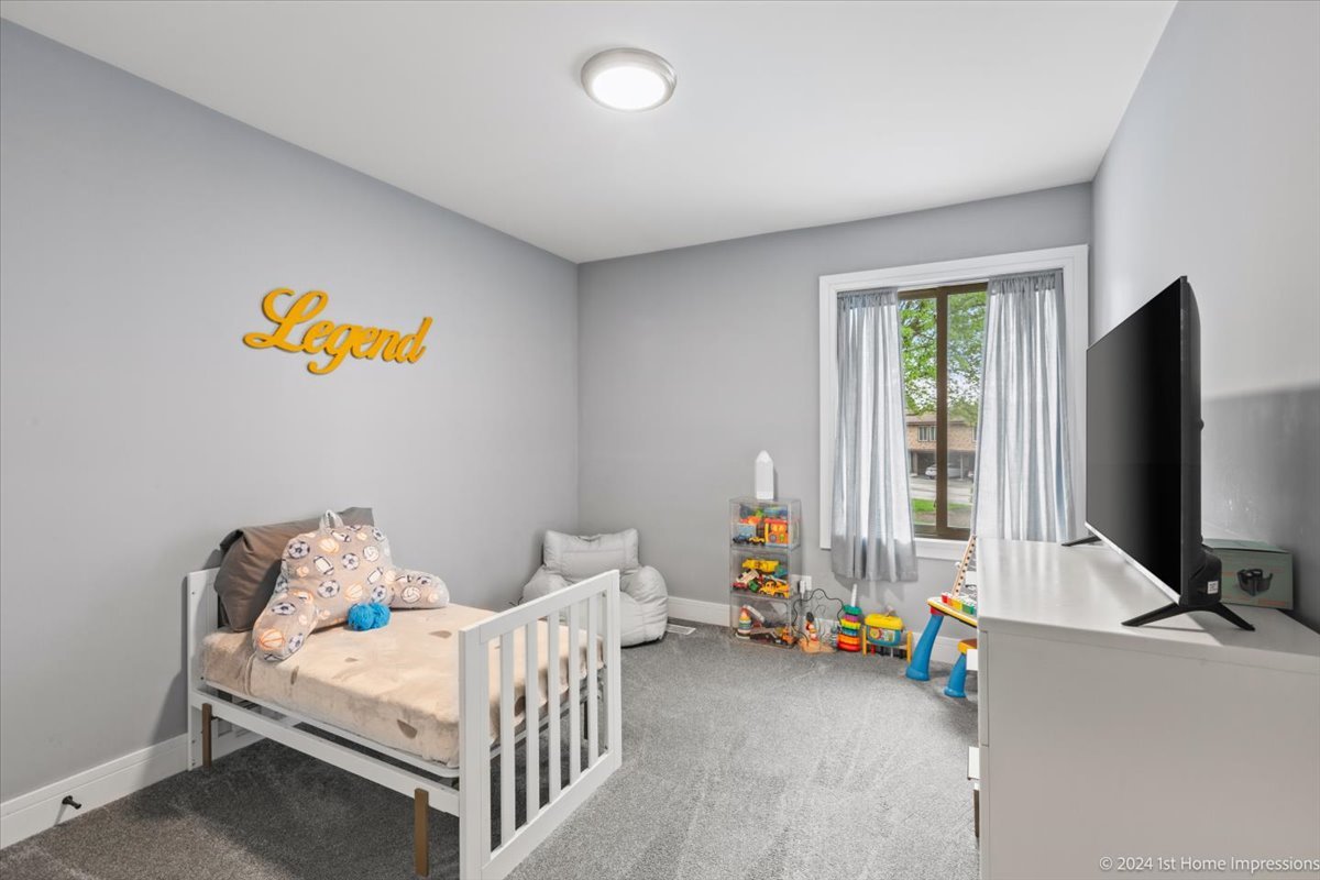 7 Cour Versaille Palos Hills, IL 60465 - Photo 15 of 20 a bedroom with a bed and a flat screen tv