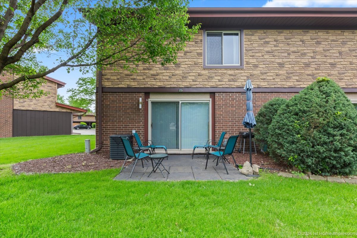 7 Cour Versaille Palos Hills, IL 60465 - Photo 19 of 20 a view of a chair and table in the back yard of the house