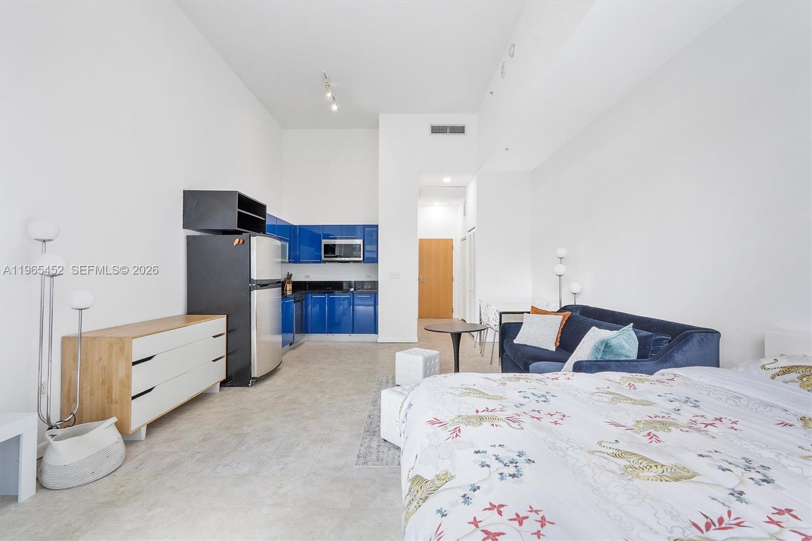 253 Northeast 2nd Street, Unit 223 Miami, FL 33132 - Photo 1 of 16 a bedroom with a bed and cabinets