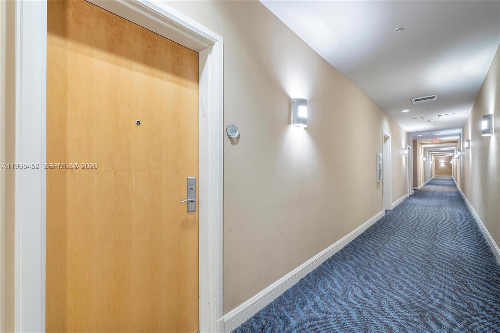 253 Northeast 2nd Street, Unit 223 Miami, FL 33132 - Photo 12 of 16 a view of a hallway with wooden floor