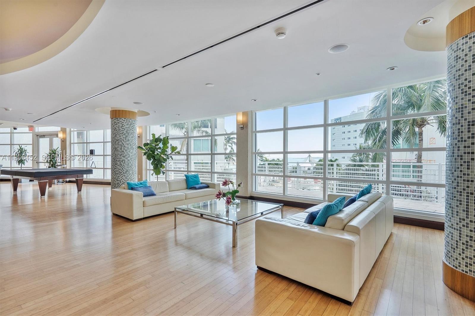 253 Northeast 2nd Street, Unit 223 Miami, FL 33132 - Photo 13 of 16 a living room with furniture and a large window