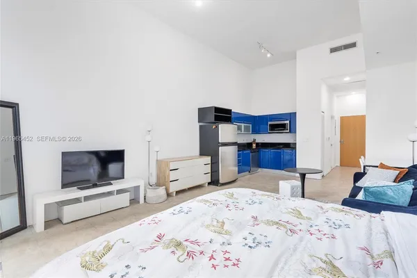 a bedroom with furniture and a flat screen tv