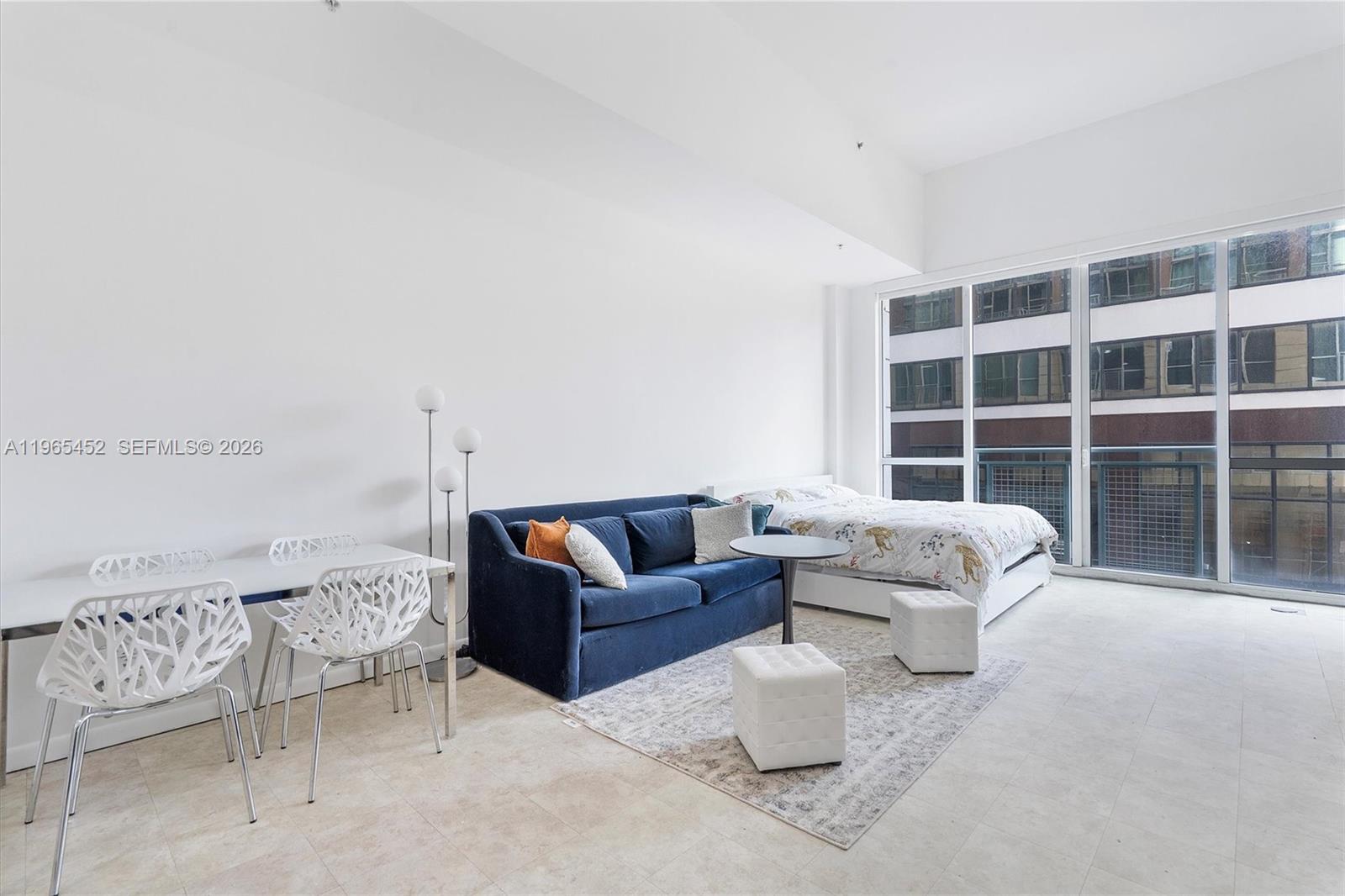 253 Northeast 2nd Street, Unit 223 Miami, FL 33132 - Photo 4 of 16 a living room with furniture and a window