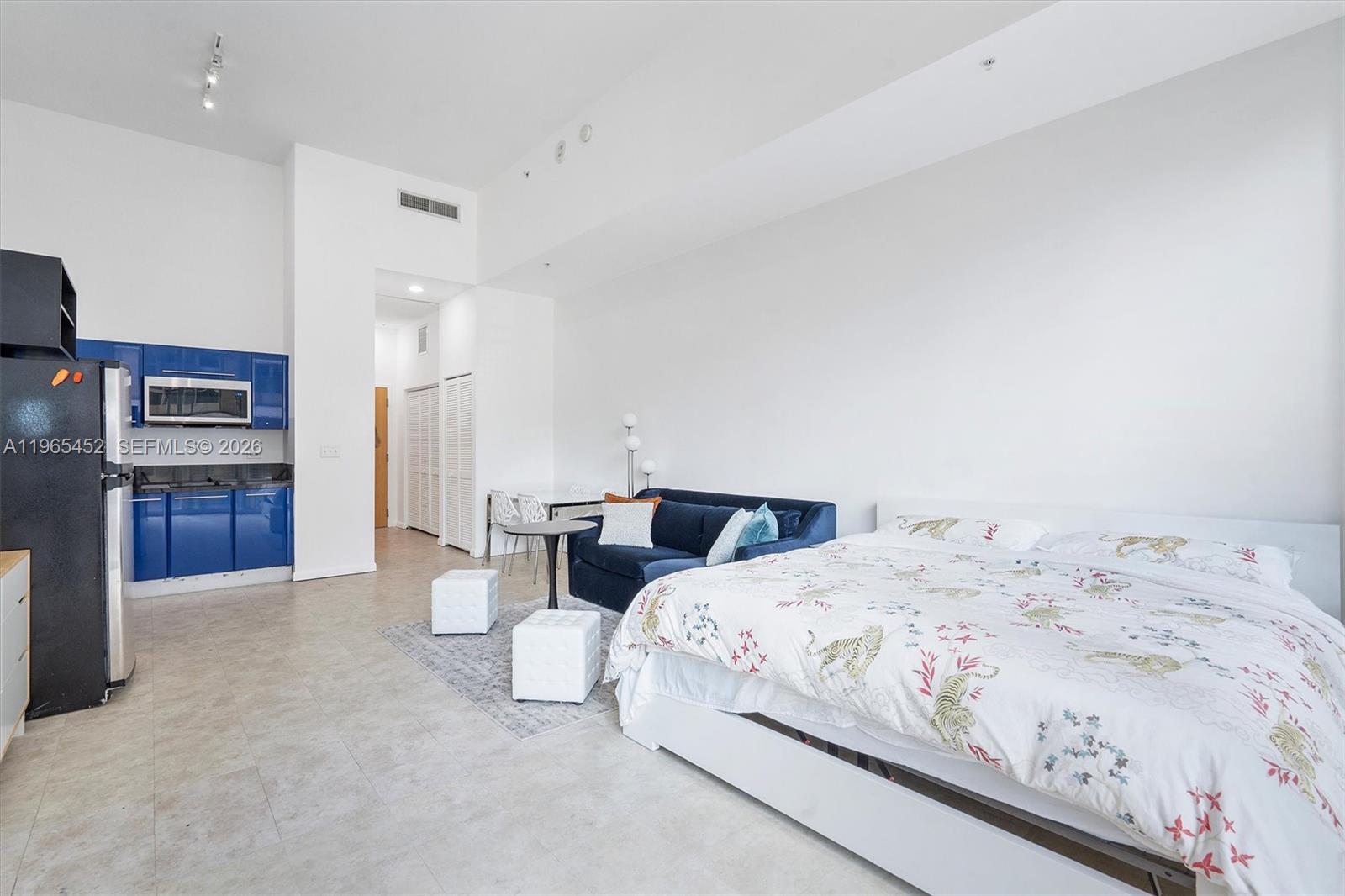 253 Northeast 2nd Street, Unit 223 Miami, FL 33132 - Photo 5 of 16 a bedroom with a bed and a television