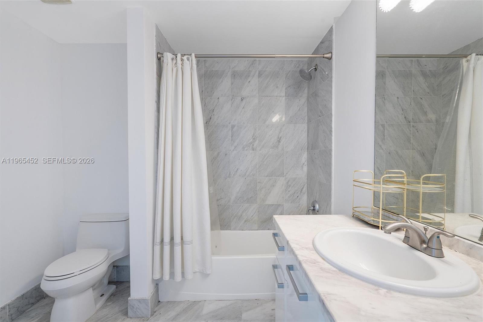 253 Northeast 2nd Street, Unit 223 Miami, FL 33132 - Photo 10 of 16 a bathroom with a sink toilet and shower