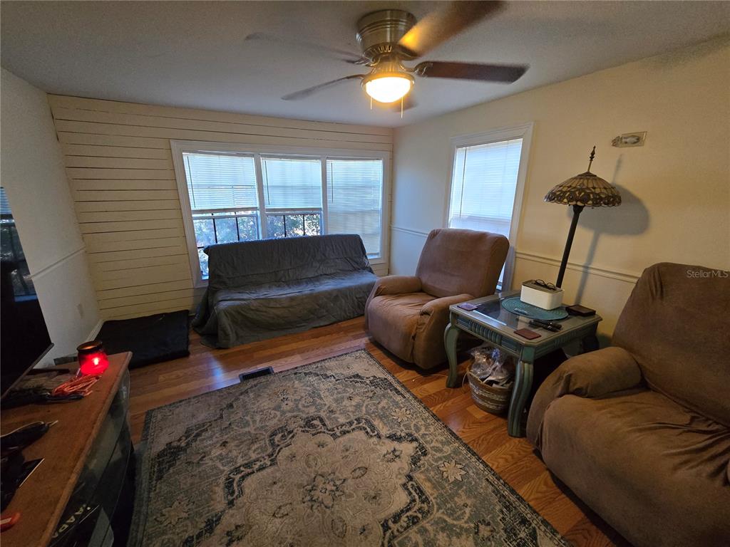 6430 West Grant Street Homosassa, FL 34448 - Photo 14 of 20 a living room with furniture a flat screen tv and a window