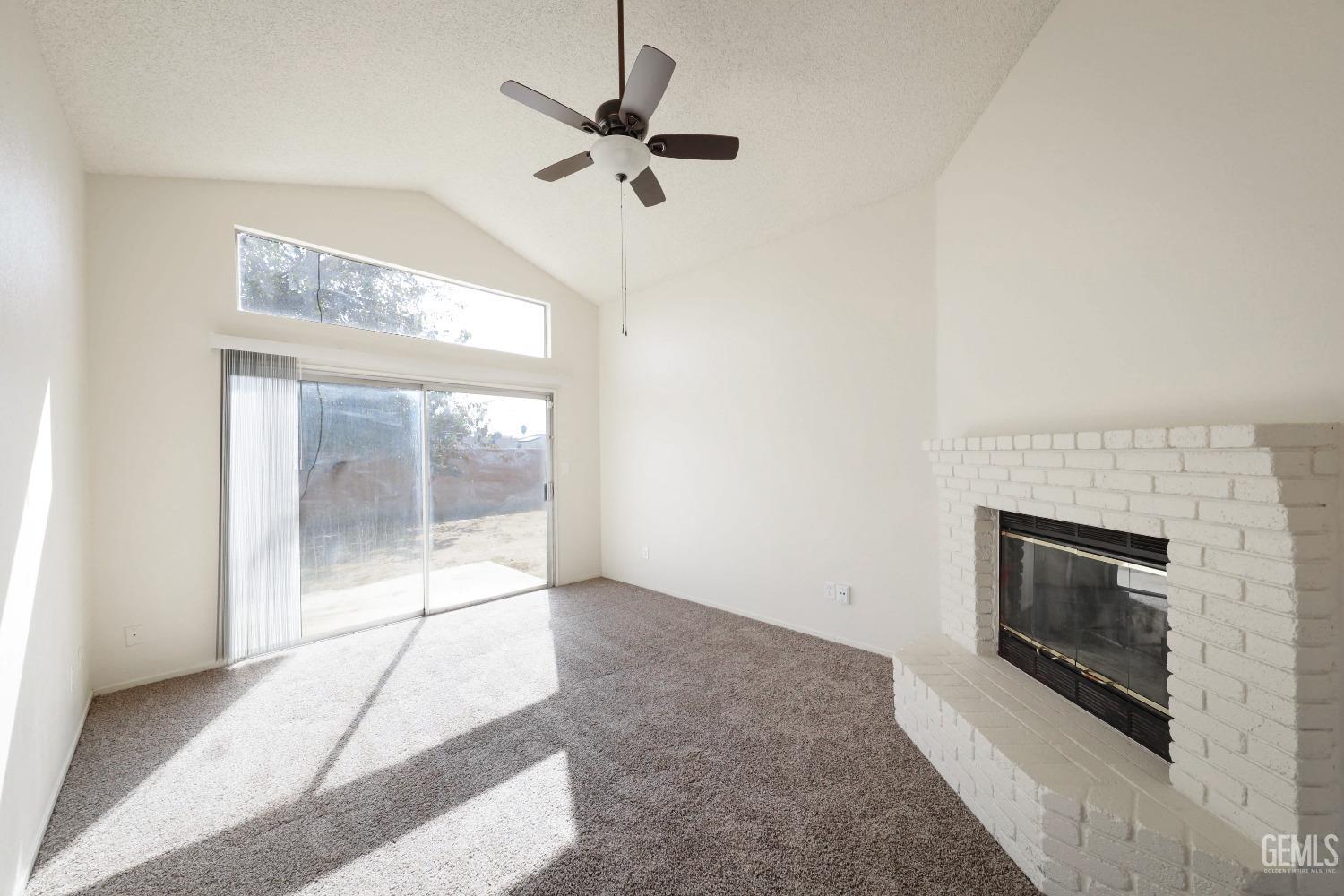 Undisclosed Address Bakersfield, CA 93304 - Photo 11 of 21 a living room with a fireplace