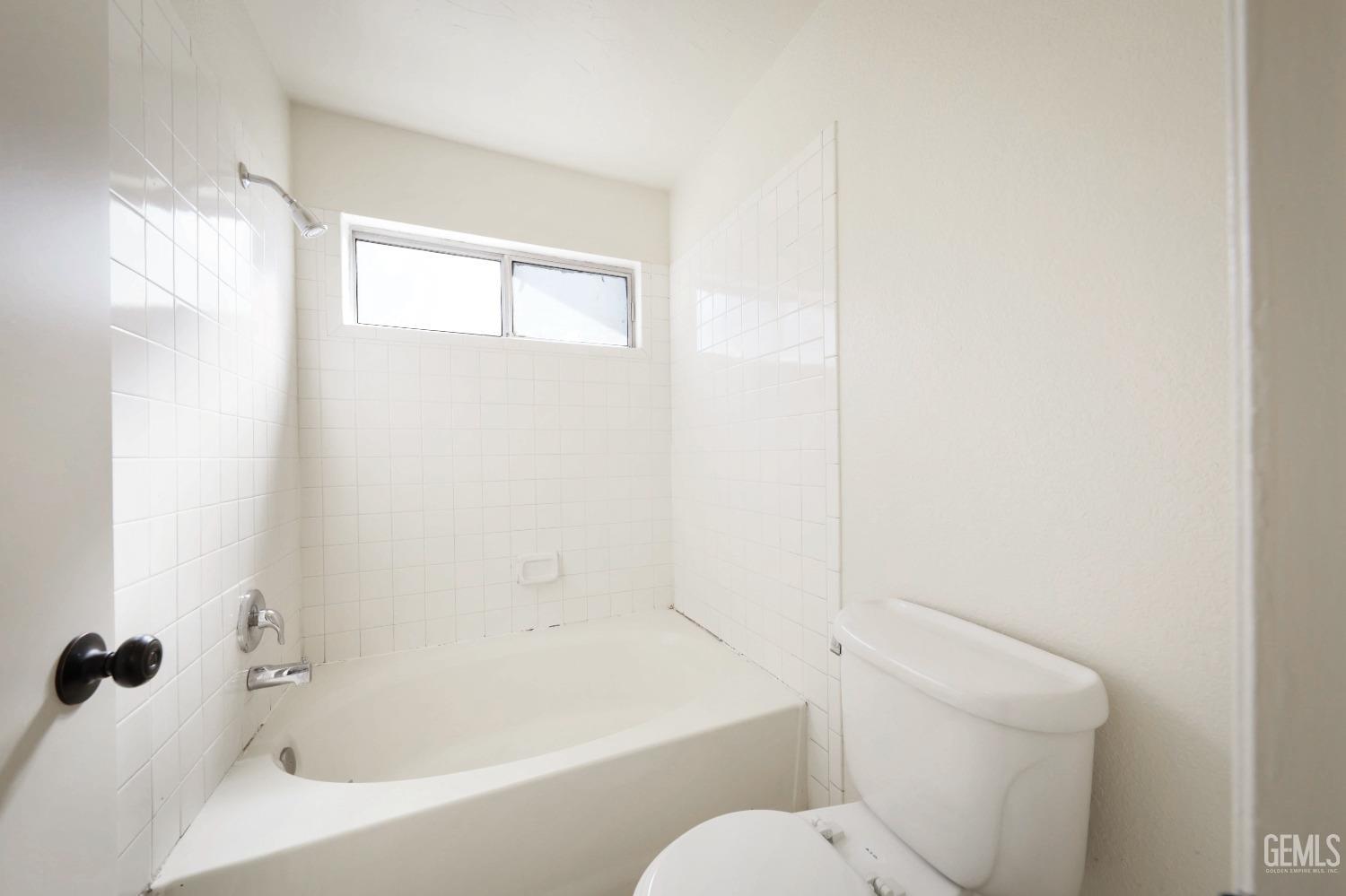 Undisclosed Address Bakersfield, CA 93304 - Photo 14 of 21 a white bath tub sitting next to a white toilet