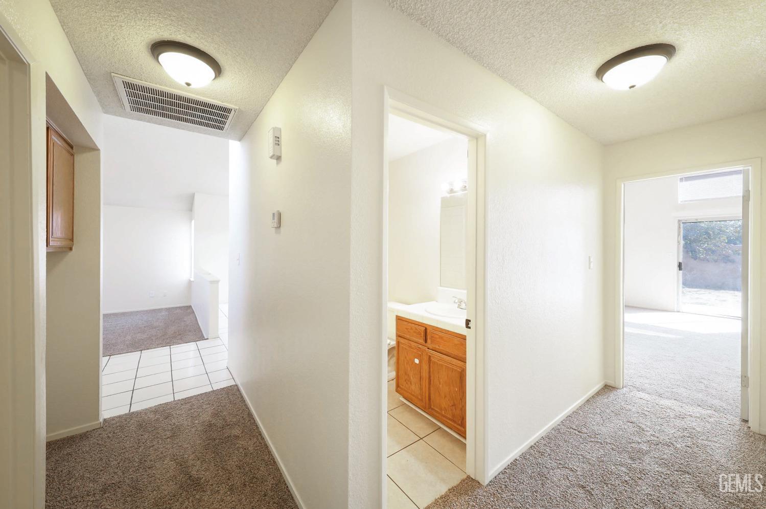 Undisclosed Address Bakersfield, CA 93304 - Photo 16 of 21 a view of a bathroom from a hallway