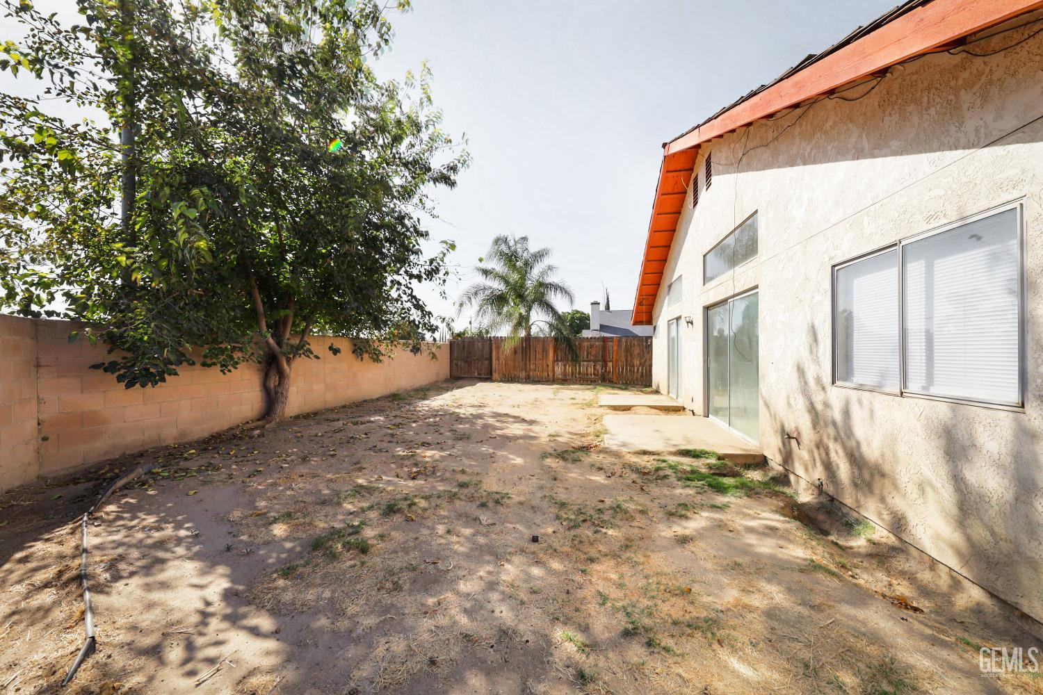 Undisclosed Address Bakersfield, CA 93304 - Photo 18 of 21 a view of a yard with a house