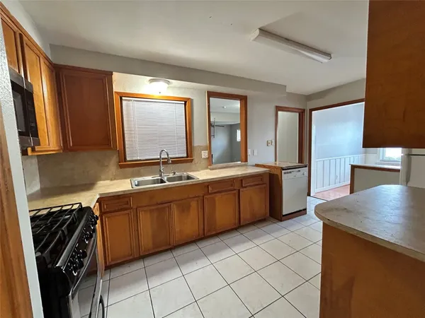 a large kitchen with a sink and cabinets