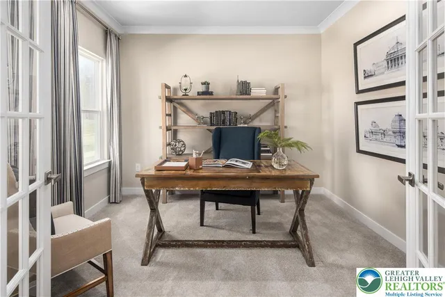 a view of a workspace with furniture and window