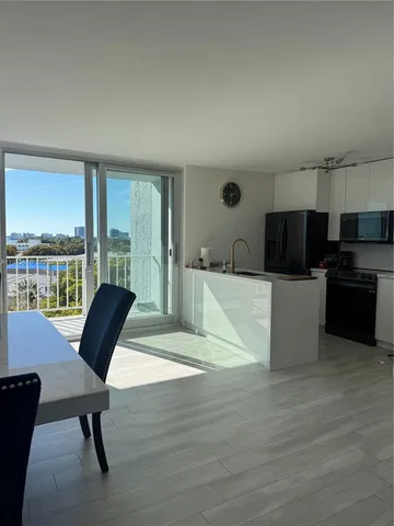 a view of kitchen with furniture and large window