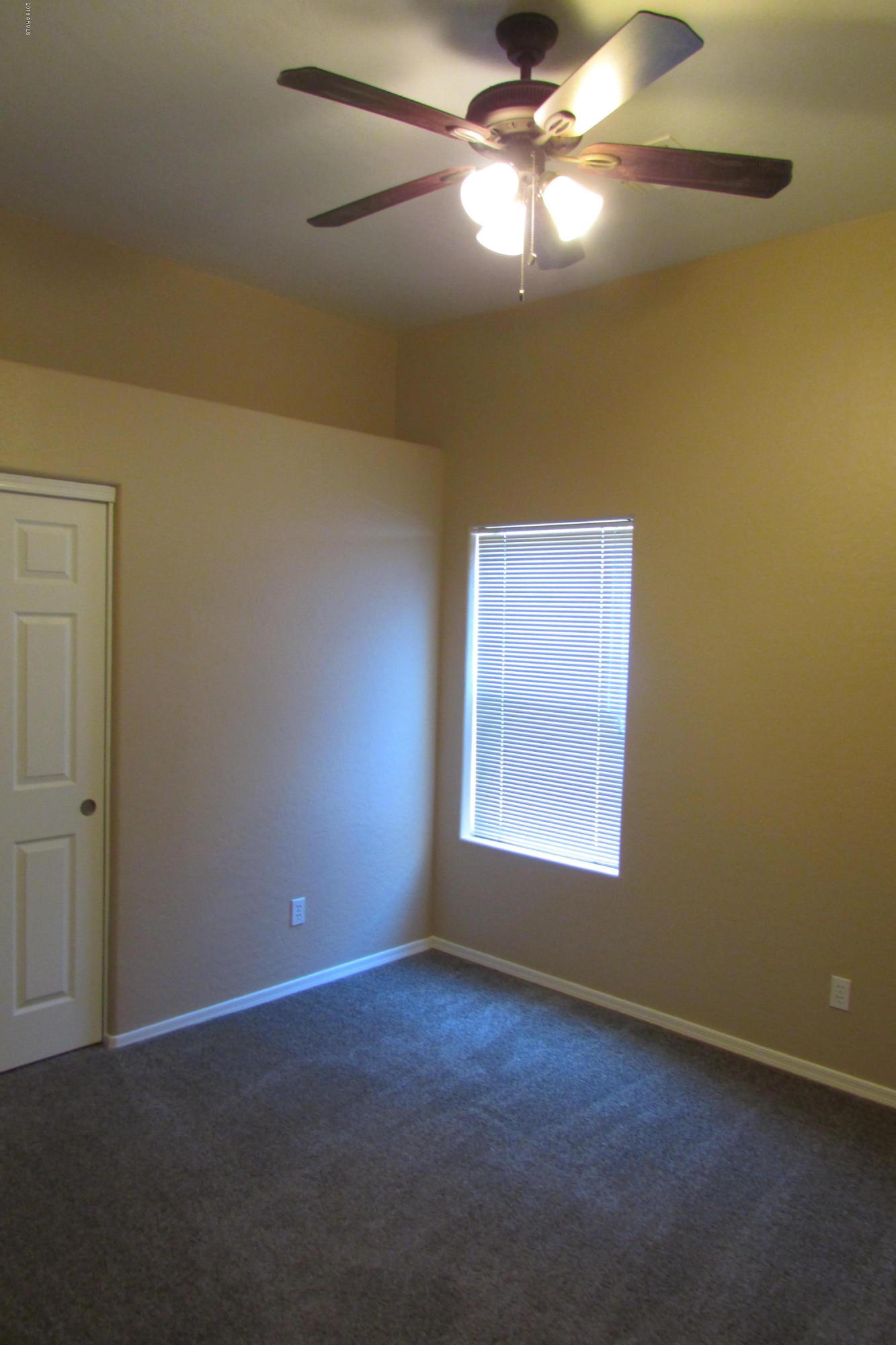 716 East Ranch Road Gilbert, AZ 85296 - Photo 12 of 22 an empty room with a window and a fan