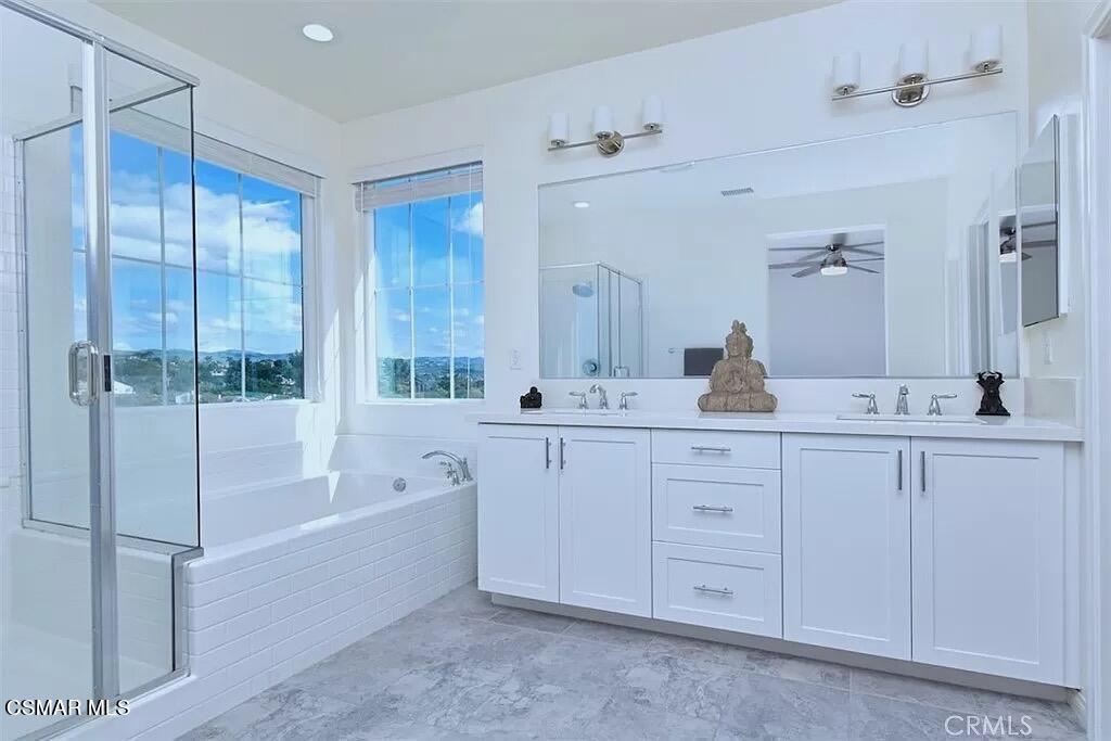 207 Morro Way, Unit 3 Simi Valley, CA 93065 - Photo 23 of 31 a spacious bathroom with a double vanity sink a mirror and a bathtub