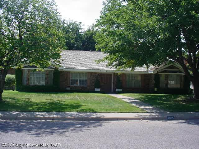 6915 Elmhurst Road Amarillo, TX 79106 - Photo 1 of 1 a front view of a house with a yard and trees