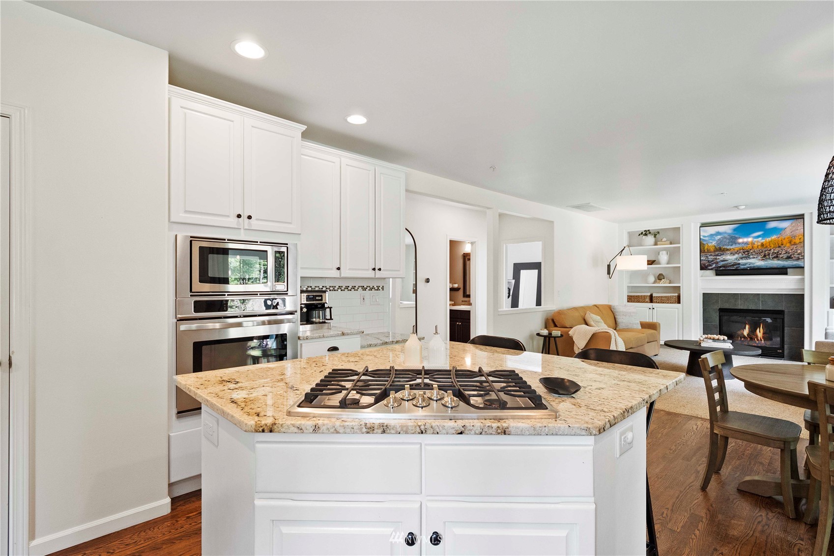 503 210 Street Southeast Bothell, WA 98021 - Photo 9 of 39 a kitchen with granite countertop a stove a sink dishwasher and a refrigerator with wooden floor