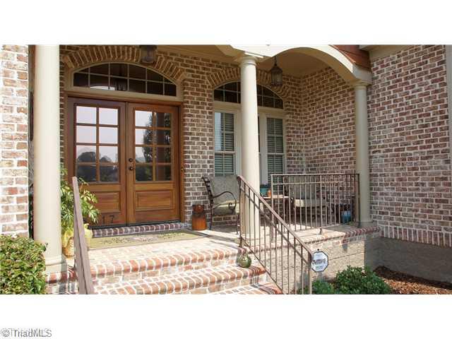 5617 Foxbury Drive Oak Ridge, NC 27310 - Photo 2 of 15 Exterior Front. Front Porch with Custom Wood Entry Double Doors, Transoms and Archways. The Brick and Mortar Exterior is a Brix Mint Brushed Joint finish. Wait until you get inside!