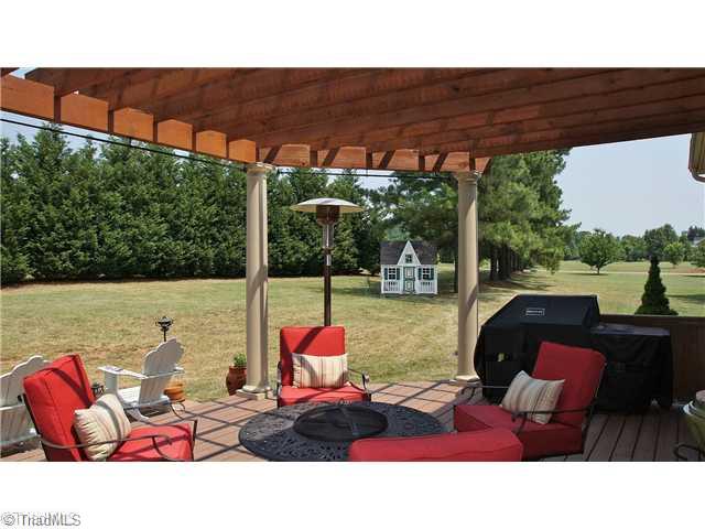 5617 Foxbury Drive Oak Ridge, NC 27310 - Photo 13 of 15 Patio/Deck. Deck with Cedar Trellis Overlooking Enormous Double Lot Yard. Surrounded by Privacy with Mature Trees. Dollhouse Remains