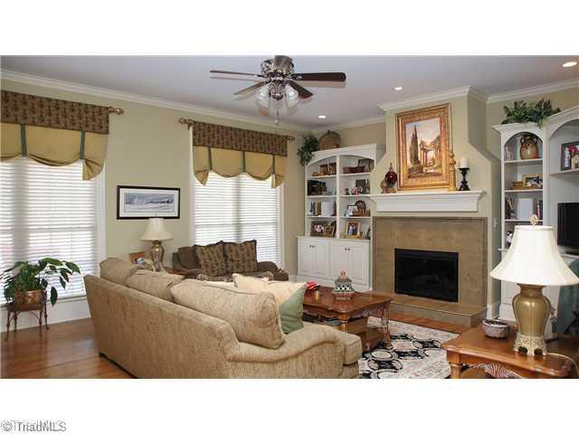 5617 Foxbury Drive Oak Ridge, NC 27310 - Photo 3 of 15 Den/Family/Great Room. Large Great Room with Hardwood Flooring and Built In Bookshelves Surrounding the Gas Log Fireplace