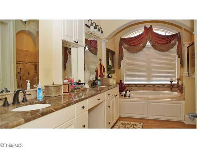 5617 Foxbury Drive Oak Ridge, NC 27310 - Photo 8 of 15 Master Bath/Spa. Totally Relax in your Spa Like Bathroom with Double Raised Vanities~Granite~Jetted Tub & MUST SEE Oversized Tiled Shower