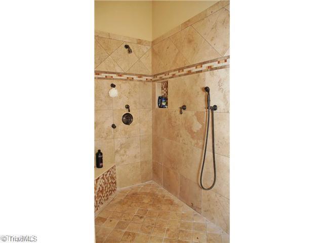 5617 Foxbury Drive Oak Ridge, NC 27310 - Photo 9 of 15 Master Bath/Spa. Oversized Tiled Shower W/Seat and Multiple Shower Heads in Oil Rubbed Bronze Finish