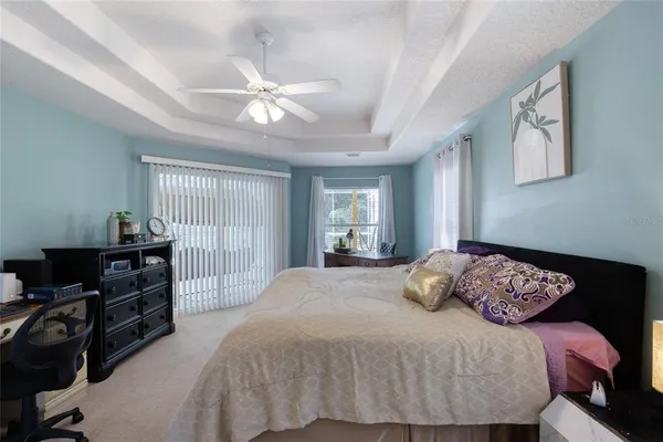 a living room with furniture a flat screen tv and a large window